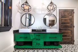 green vanity with black and white tile