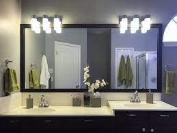 It's made from metal and features a round backplate and a horizontal arm that supports two ribbed glass bowl shades. Bathroom Vanity Lighting Light Fixtures