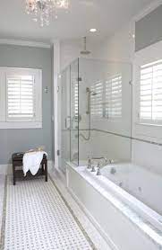 Tiling halfway up the walls with a deeper grey, and painting the rest with a lighter shade really adds height to a small bathroom. Pin By Kimberly Schwank On Home Bathroom Design Bathroom Remodel Master Shower Tub