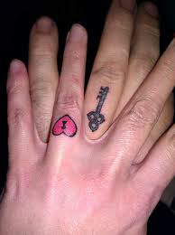 Initials of your spouse or the name is a very romantic wedding tattoo idea! Fire Dancers Tattoos And One Nerd Tastic Groom S Cake Offbeat Bride Finger Tattoos For Couples Wedding Band Tattoo Wedding Ring Finger Tattoos