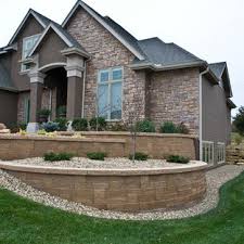 It helps present a level transition from siding to mounted fixtures. Tiered Retaining Wall Houzz