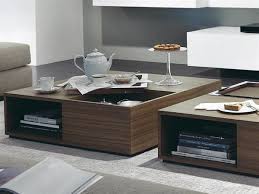 Marrying modern and glamorous elements, this two tier coffee table sets a sleek and chic foundation in your living room layout. 10 Modern Coffee Tables Wooden Coffee Table Designs Coffee Table Design Coffee Table Square
