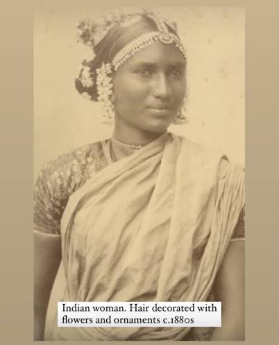 Queen Sethu Lakshmi Bayi (standing) and her younger sister (on the floor). Both the sisters were adopted into the House of Travancore, as the royal family had no female heir. The involvement
