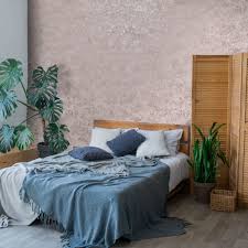 In this pink and blue bedroom. Holden Decor Obsidian Concrete Texture Pink Rose Gold Metallic Wallpaper 75960