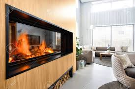 1 must have during our house hunt, and our here's why, like my brother, i've learned to love our wood stove over any fireplace a fireplace is toasty and cozy, no doubt. Large Modern Glass Fireplace On A Wooden Wall In A Modern Interior With A Wood Shelf Stock Photo Picture And Royalty Free Image Image 140017107