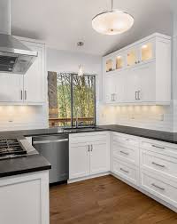 White cabinets with black soapstone countertops and light wood floor. White Cabinets With Black Countertops Houzz