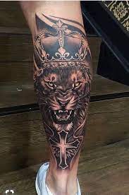 Large Roaring Lion Wearing A Crown Leg Tattoo Arm Tattoos For Man Wooden Steps Man Wearing Blue Sneake Bull Tattoos Animal Tattoos For Men Calf Tattoo Men