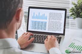 Business Man Reading Financial Analytics Report With Charts