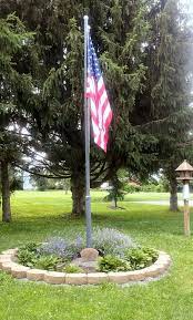 A clean and beautiful flag flying atop a tall flagpole is a symbol of freedom and independence. 17 Flag Pole Landscaping Ideas Flag Pole Landscaping Flag Pole Backyard Landscaping