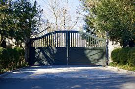 They are usually made of wood or composite material. Farmhouse Driveway Gate Gets A Modern Look With Dark Paint Driveway Gate Entrance Gates Driveway Driveway Landscaping