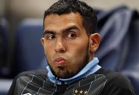 Manchester City's Carlos Tevez sits