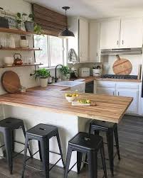 Our kitchen designers can help! Picture Of A U Shaped Kitchen With White Cabinetry Butcherblock Countertops And A Woven Shade Plus Black Stools