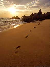 Futuristic sunrise on the beach human footprints on the sand, sun, summer, vacations, nature. Footprints In The Sand Footsteps In The Sand Beach Scenes Beach