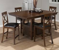 It has two chairs and a table with an oval tabletop. Olsen Oak Casual Counter Height Rectangle Table With Storage Pedestal Base By Jofran Nis978203292 Bruce Furniture Flooring