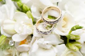 Wedding bouquet of white roses and buttercup on a wooden table. Two Wedding Rings On Bridal Bouquet Stock Photos Freeimages Com
