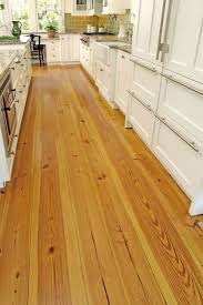Wide Plank Heart Pine Flooring From Carlisle Wide Plank Floors Make This Cozy Galley Kitchen Look A Little Bit Bigg Pine Kitchen Pine Wood Flooring Pine Floors