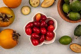 Free Photo Top View Of Delicious Cornelian Cherries On A Bowl With Feijoas And Persimmons Isolated On A Grey Background
