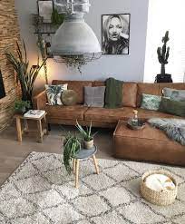 Several pieces of rattan furniture make the space tropical. Boho Home Leather Couches Living Room Brown Sofa Living Room Brown Couch Living Room