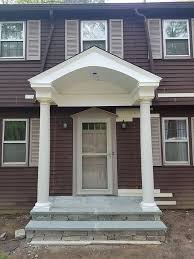 A gate with a small roof over it at the entrance to a churchyard. Windows And Doors Zn Construction Contracting Canton Ct