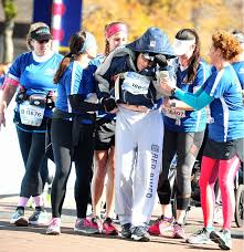 More than 12,000 runners, walkers and wheelchair competitors cross the finish line each year in the dallas marathon & half marathon. Dallas Marathon Runners At Pate Includes Wheelchair Push Team