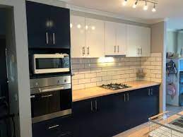 Sitting atop four raised legs, the pieces also feature a durable granite countertop and a glossy modern white finish, accentuated with shiny bronze pulls. Kitchen Kitchen Renovations Appliances Bunnings New Zealand