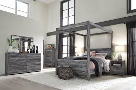 Fall asleep in sophistication with this queen bedroom set, crafted in a smoky gray finish, with led lights in the headboard for nighttime reading. Ashley Furniture Baystorm Queen Canopy 6 Piece Bedroom