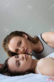 Sensual Lesbian Women In Underwear Lying On Bed And Looking At Camera  Isolated On Grey Stock Photo, Picture and Royalty Free Image. Image  192319528.