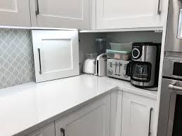 If you have several small appliances, consider dedicating an entire cabinet as an appliance garage. Appliance Garage Doors