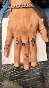 Finger tattoo design with snake rose and musical notes
