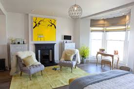 Modern primary bedroom featuring light brown walls and a stunning ceiling, along with white carpet floors and a fireplace with a tv on top. 9 Ways To Make The Most Of A Bedroom Fireplace Houzz Uk