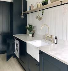 A modish laundry room and kitchen white laundry room and comfort room combo with black tiles flooring making the area looks stylish. 13 Beautiful Laundry Rooms Decorating Ideas For Laundry Rooms