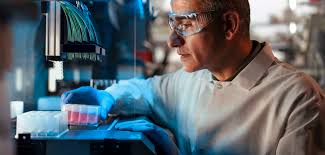 A Johnson & Johnson associate works with a mini-bioreactor.