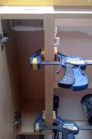 For uneven walls, clamp the filler strip to the outside of the cabinet face. How To Install Kitchen Cabinets To The Wall And Floor With Ease