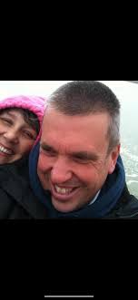 Can you restore this photo of my husband and I dancing in the kitchen?
