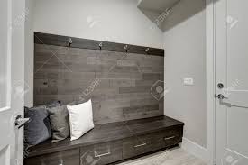 Modern bright flat interior design with yellow accents. Gray Foyer Features Half Wood Plank Accent Wall With Built In Stock Photo Picture And Royalty Free Image Image 70209178