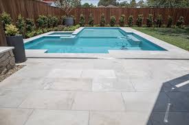 Concrete pool pavers make an ideal pool deck material because they easily combine the affordability of concrete with the elegance of natural stone. Merino Marble Pavers And Marble Pavers By Armstone Travertine Pool Travertine Pool Decking Pool Patio Pavers