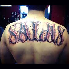 This is what inspires tattoo artists to include names in some personalized tattoo designs, which can be the bearer's own name or the name of his loved ones. Last Name On Back Tattoo Idea
