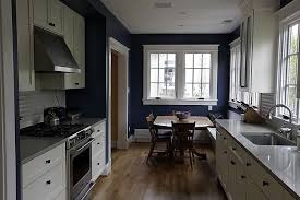 navy blue walls, white cabinets, wood