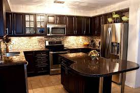 The dark granite countertop complements the woodwork and the dark glass in the stainless steel appliances. Dark Granite Countertops With Dark Cabinets Furnituretexture Club Black Granite Countertops Dark Wood Kitchen Cabinets Brown Kitchen Cabinets