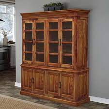 Made from a mix of solid and manufactured wood, this piece strikes a tall and narrow silhouette measuring 72'' h x 31.25'' w x 15.85'' d for a compact footprint. Oklahoma Rustic Solid Wood Glass Door Dining Room Hutch