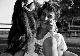 A teen couple peeking out from behind a tree in the forest. Pin By Emily Gooms On Love Cute Couples Kids In Love Cute Couple Pictures