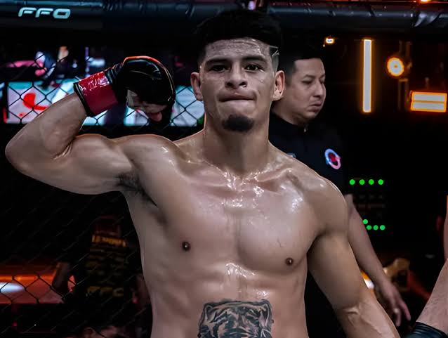 Nilson Rojas flexing in the cage after a regional bout