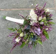 At this unique wedding, seasonal roses, dusty miller, astrantia, jasmine vines, and protea were used in the bride's cascading bouquet, made by blossom and branch. Pin By Emma Colbey On Wedding Flowers Floristry Design Heather Flower Thistle Bouquet Wedding