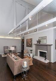 Vaulted ceilings can create a striking look in any room, making spaces feel larger and more open. Whitetongue And Groove Vaulted Ceiling With Exposed Beams This Track Lighting But Vaulted Ceiling Living Room Vaulted Ceiling Lighting Sloped Ceiling Lighting