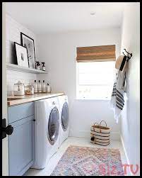Farmhouse style laundry room featuring navy patterned cement tile flooring, custom white overlay cabinets, brass cabinet hardware. Pin On Laundry Room