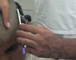 صورة person shaving their head during Umrah