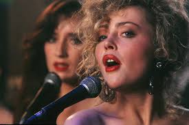 Maria doyle kennedy is wearing a vibrantly coloured 1960s silk suit. The Commitments 1991