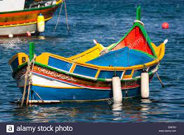 Colourful Traditional Maltese Fishing Boat At Anchor On The Water Malta Stock Photo Fishing Boats Boat Malta Beaches