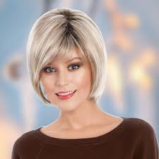 Avery from Tony of Beverly is the epitome of chic sophistication, featuring  mid-length layers that gracefully cascade from the shoulders. With its  sleek silhouette and dimensional side-swept bangs, Avery offers a versatile