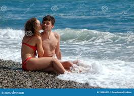 Man and Woman are Kissed on Beach Stock Image - Image of wave, couple:  13385477